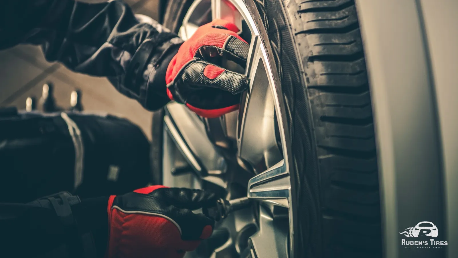 Mechanic inspecting tire pressure during routine car maintenance at Ruben's Tires.