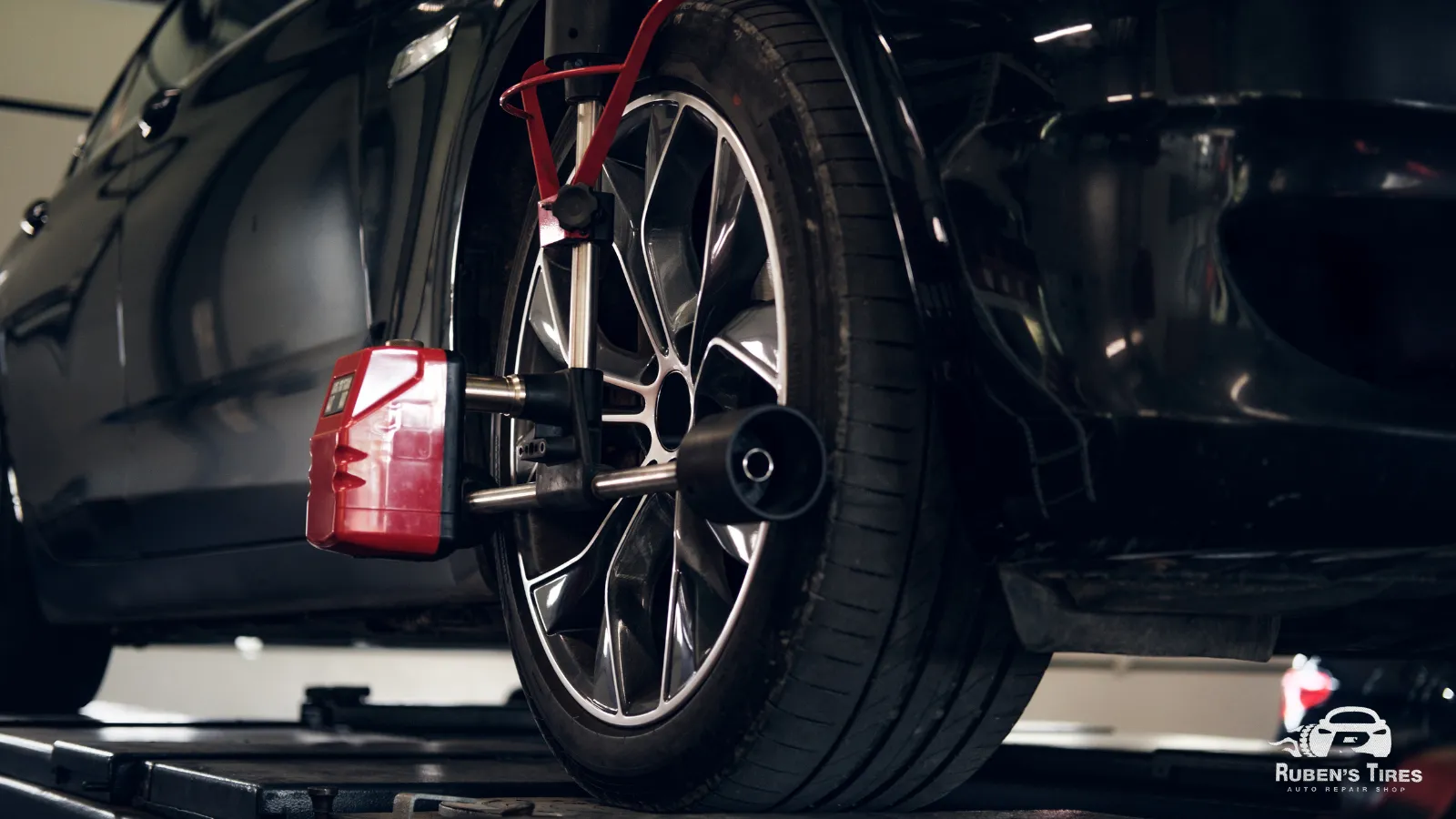 Advanced tire alignment equipment used during car maintenance at Ruben's Tires.