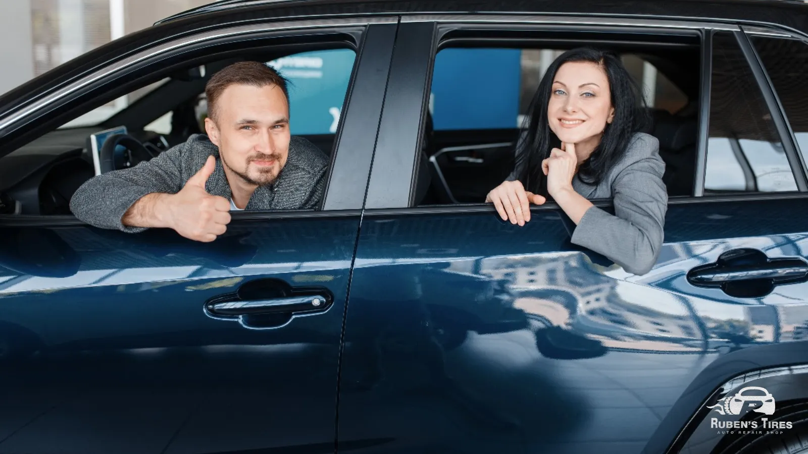 Happy customers giving a thumbs-up from their car after service at Ruben’s Auto Repair.