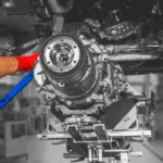 Mechanic using precision tools to perform detailed engine work in a modern garage, showcasing expert Engine Repair Central Florida services for reliable performance.