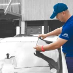 Certified technician carefully installing window film on a vehicle, delivering professional Car Window Tinting Central Florida services for UV protection and enhanced privacy.