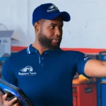 Ruben’s Tires team member providing expert guidance in a professional garage setting, embodying the service excellence highlighted in About Rubens Tires Central Florida.