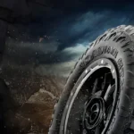 Close-up of rugged tire on a vehicle driving through rough terrain, illustrating expert Auto Repair Tips Central Florida for off-road tire maintenance and durability.